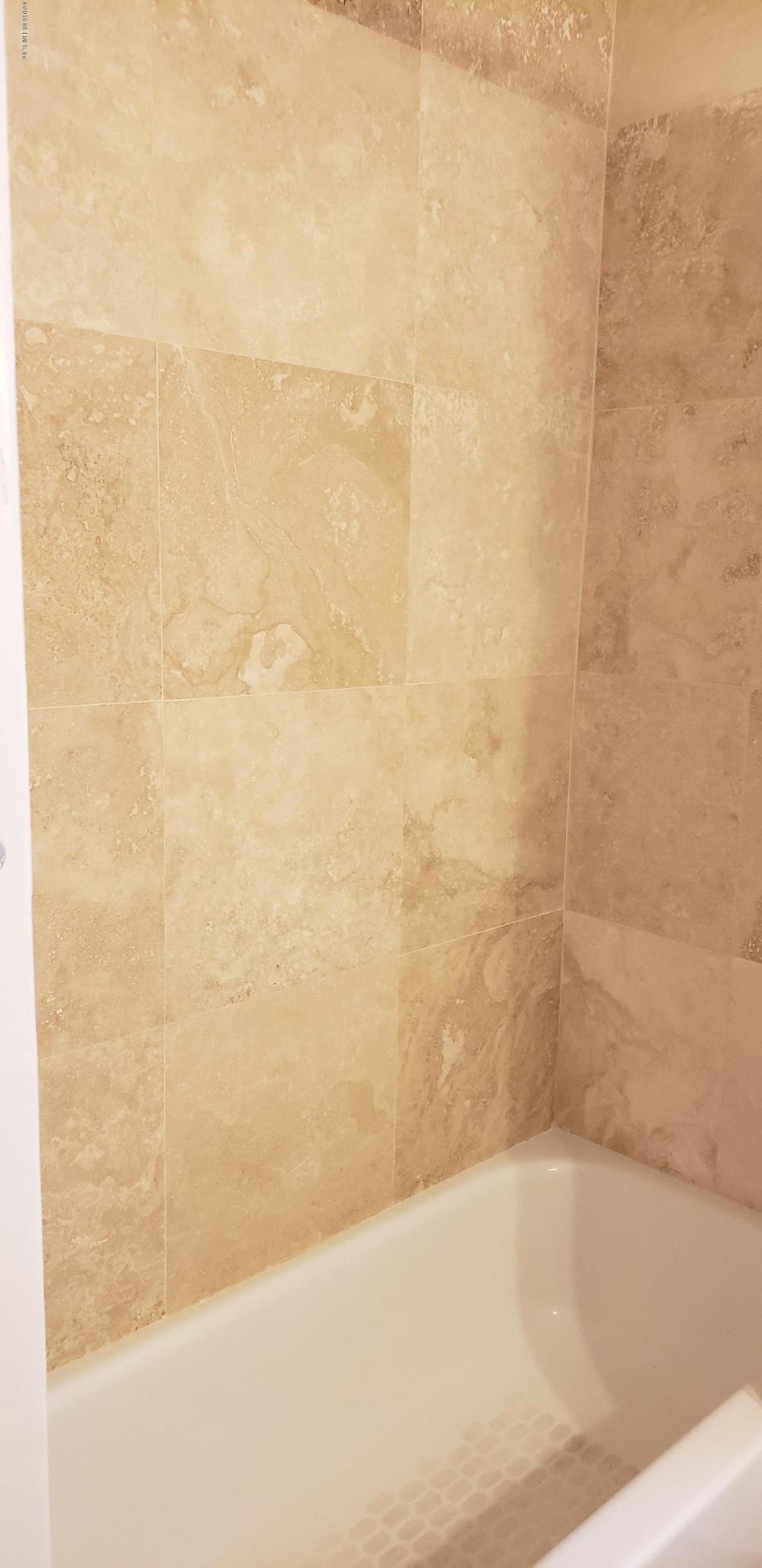 4633 Manchester Road Jacksonville, FL 32210 - Photo 4 of 26 a bathroom with a bathtub