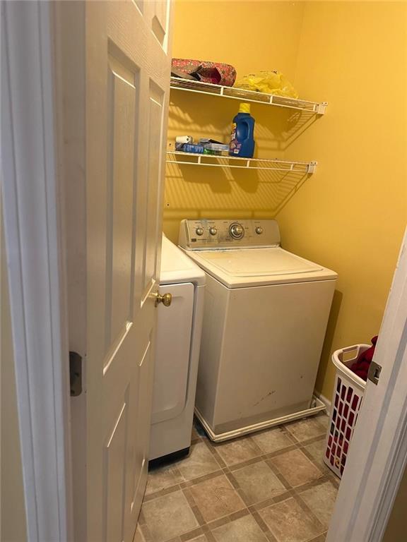 928 Shannon Road Southwest Loganville, GA 30052 - Photo 14 of 16 a utility room with dryer and washer