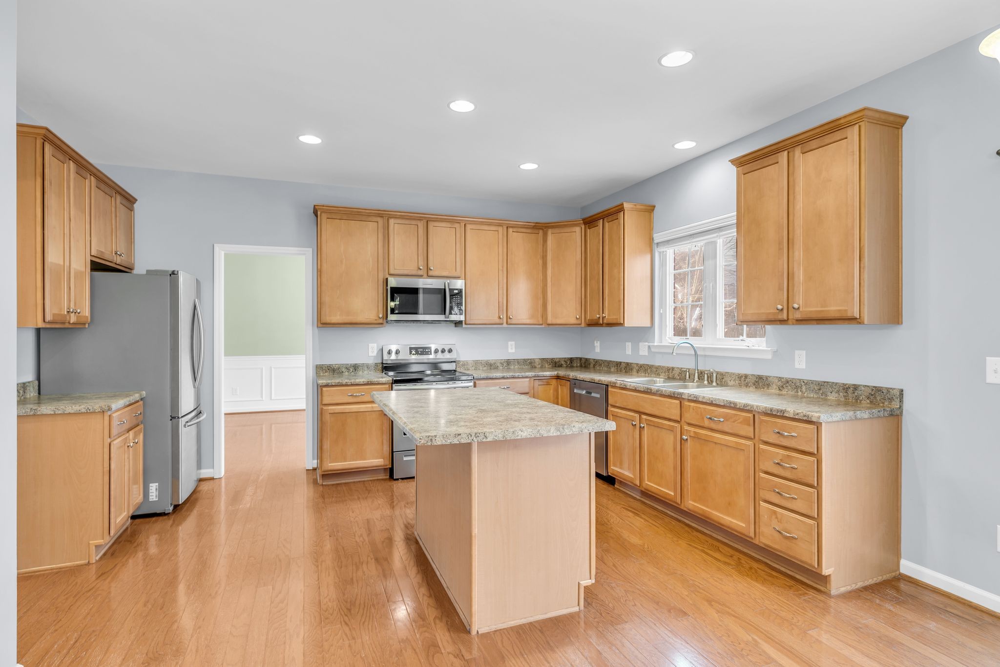 105 Lagan Court Franklin, TN 37064 - Photo 15 of 51 a kitchen with stainless steel appliances granite countertop a stove a sink dishwasher a refrigerator and white cabinets with wooden floor