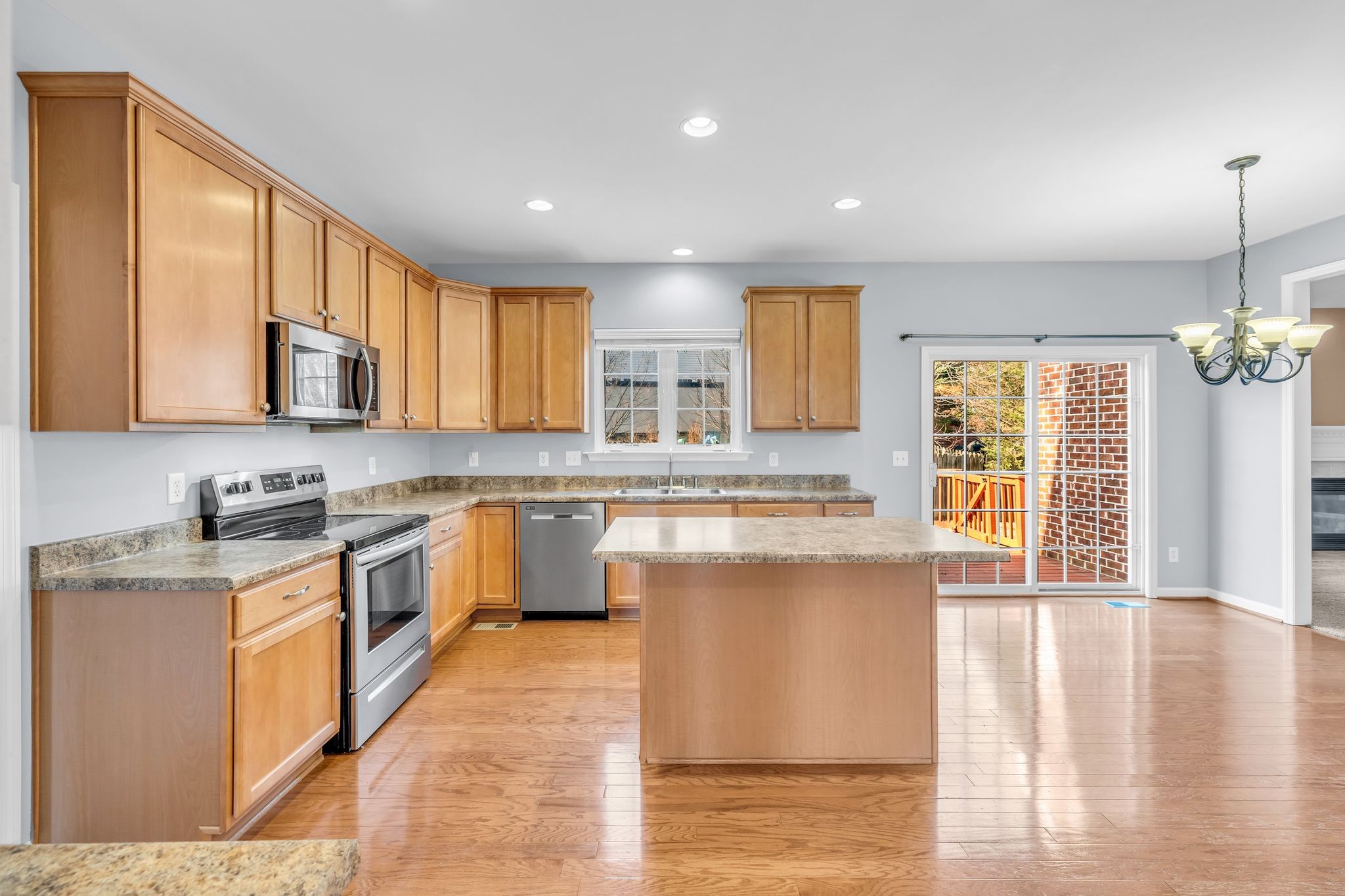105 Lagan Court Franklin, TN 37064 - Photo 16 of 51 a kitchen with stainless steel appliances granite countertop a stove a sink dishwasher and a microwave oven with wooden floor