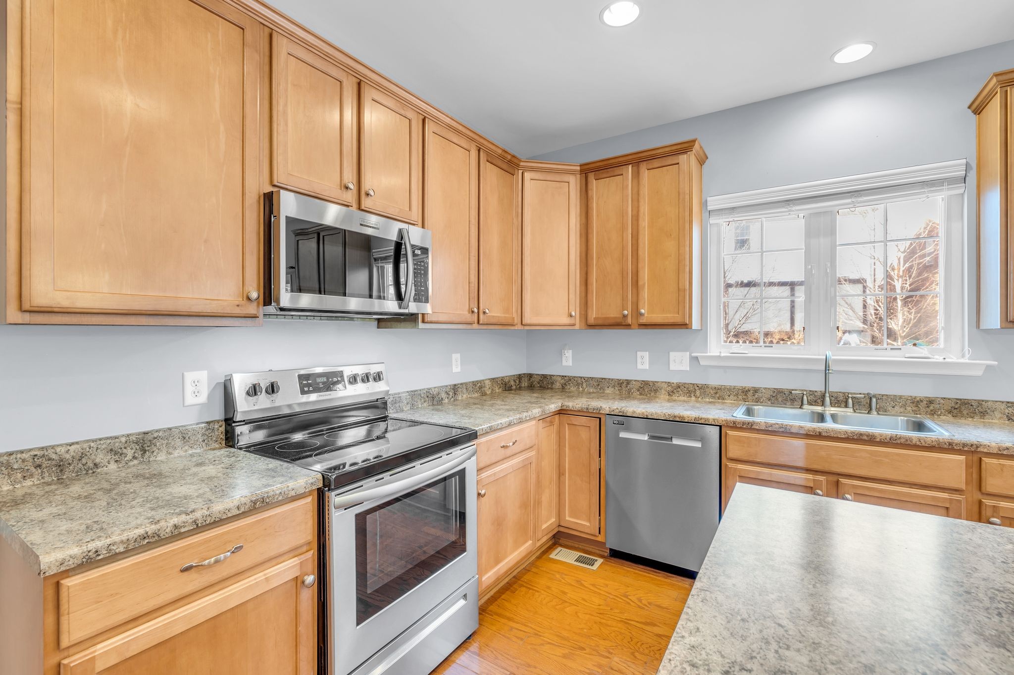 105 Lagan Court Franklin, TN 37064 - Photo 17 of 51 a kitchen with stainless steel appliances granite countertop a stove a sink and a microwave