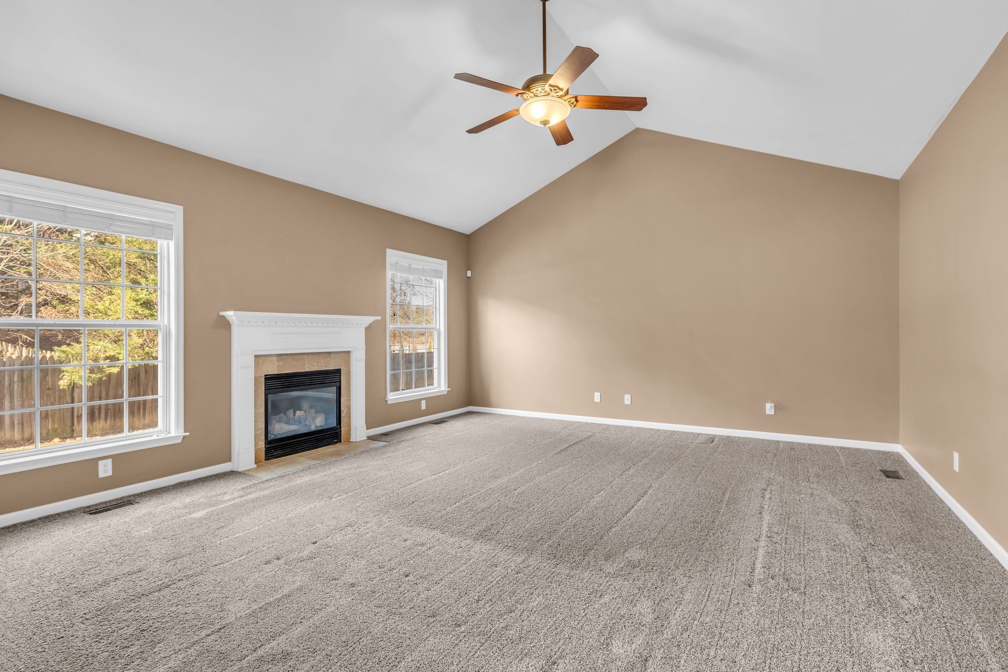 105 Lagan Court Franklin, TN 37064 - Photo 25 of 51 a view of an empty room with a fireplace and a window