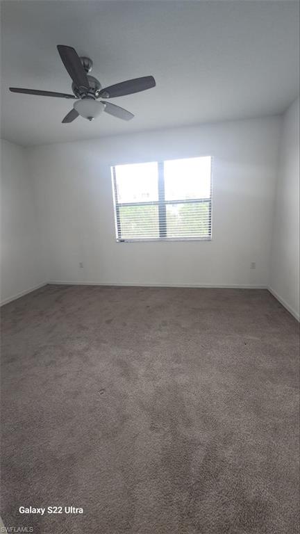9015 Madrid Circle Naples, FL 34104 - Photo 12 of 15 Carpeted spare room with baseboards