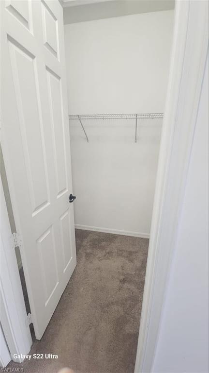 9015 Madrid Circle Naples, FL 34104 - Photo 14 of 15 Spacious closet featuring carpet floors