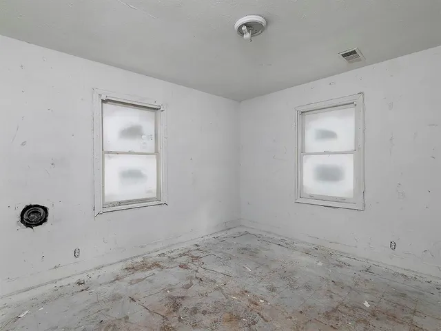 an empty room with closet area