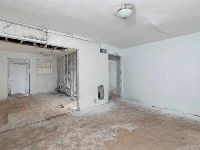 an empty room with a empty space and windows