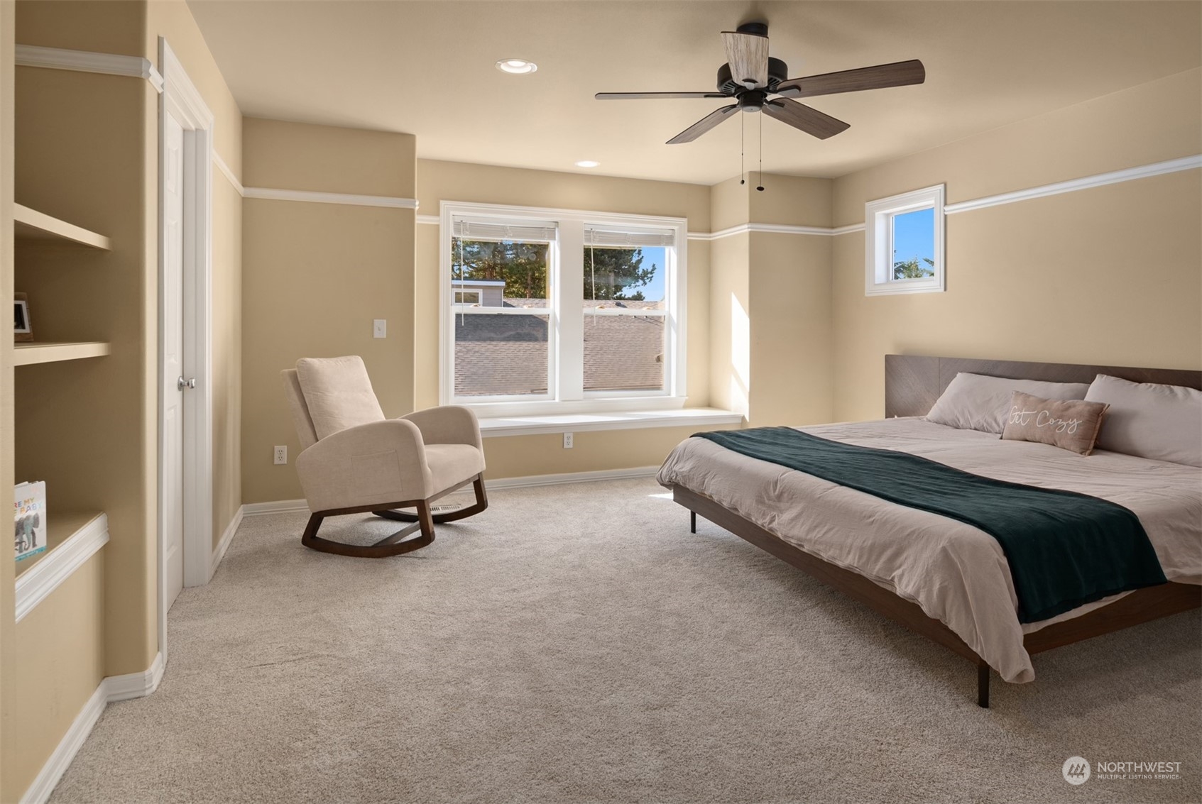 10217 Southeast 237th Street Kent, WA 98031 - Photo 12 of 28 a spacious bedroom with a bed a chair and a chandelier