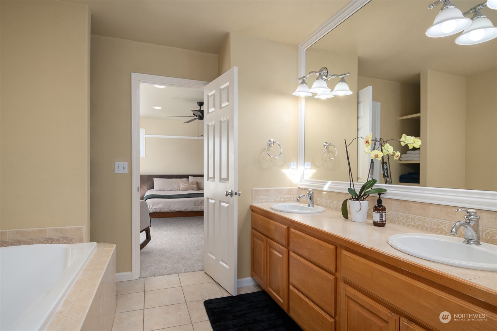 10217 Southeast 237th Street Kent, WA 98031 - Photo 15 of 28 a bathroom with a double vanity sink a mirror and a bathtub