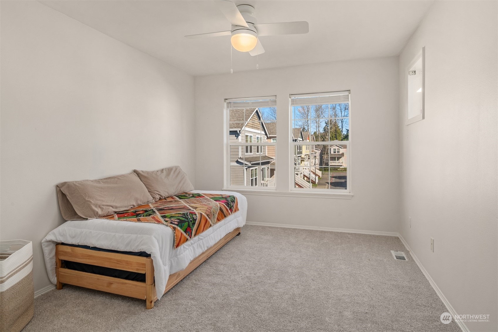 10217 Southeast 237th Street Kent, WA 98031 - Photo 18 of 28 a spacious bedroom with a bed and window