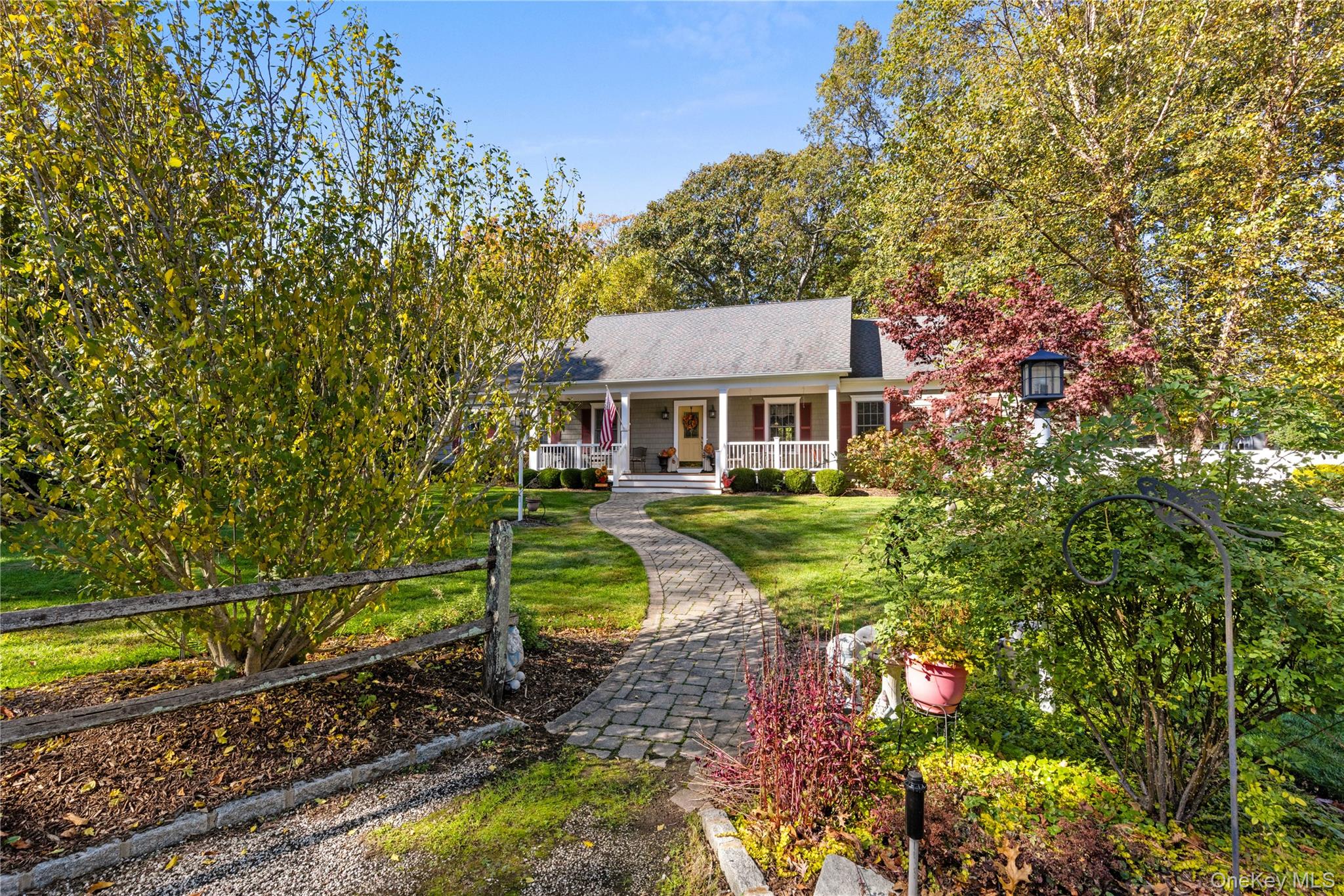 a aerial view of a house with a yard table and chairs