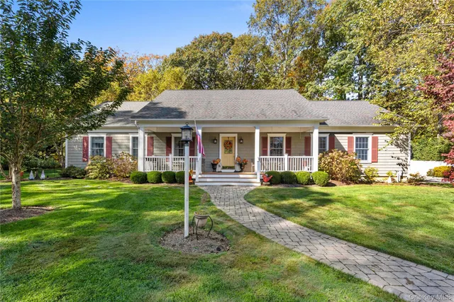 a front view of a house with a yard and porch