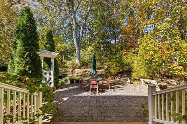 a view of a patio with table and chairs and potted plants