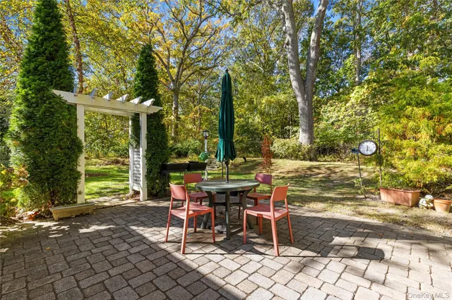a view of a patio with table and chairs and potted plants