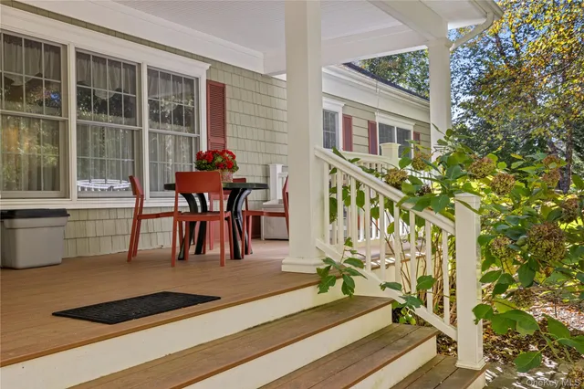 a dining room with furniture and a potted plant