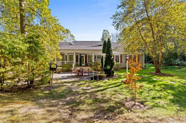 a view of a house with swimming pool and sitting area