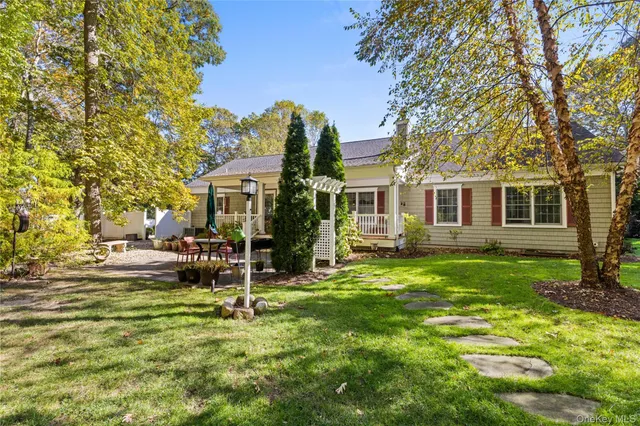 a view of a house with a yard and sitting area
