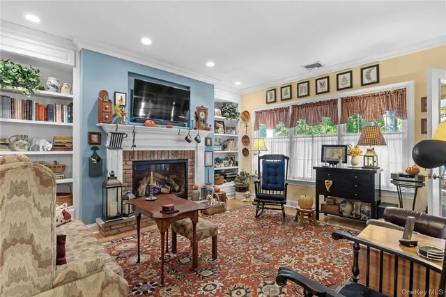 a living room with furniture a fireplace and a flat screen tv