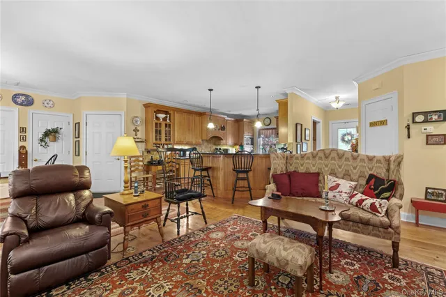 a living room with furniture and a view of kitchen