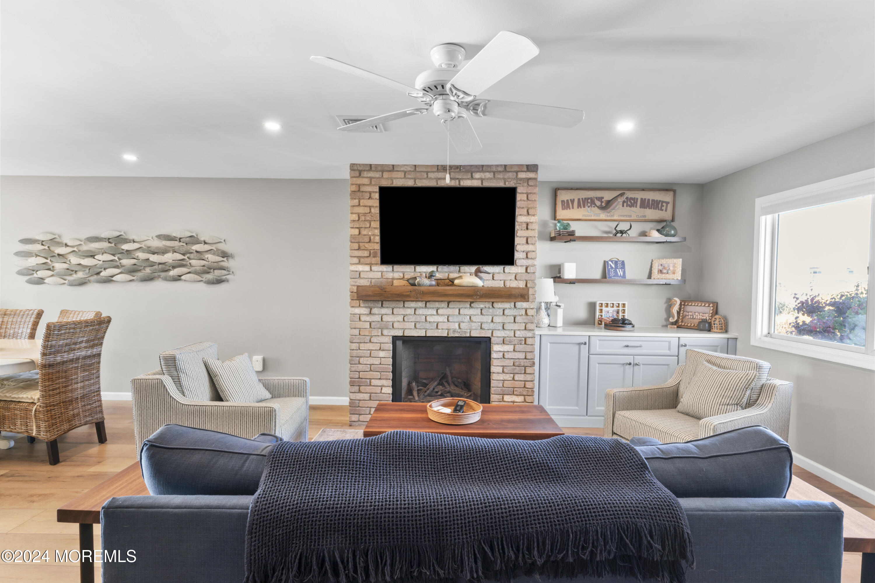 441 East Bay Avenue, Unit 10 Barnegat, NJ 08005 - Photo 12 of 53 a living room with furniture a fireplace and a flat screen tv
