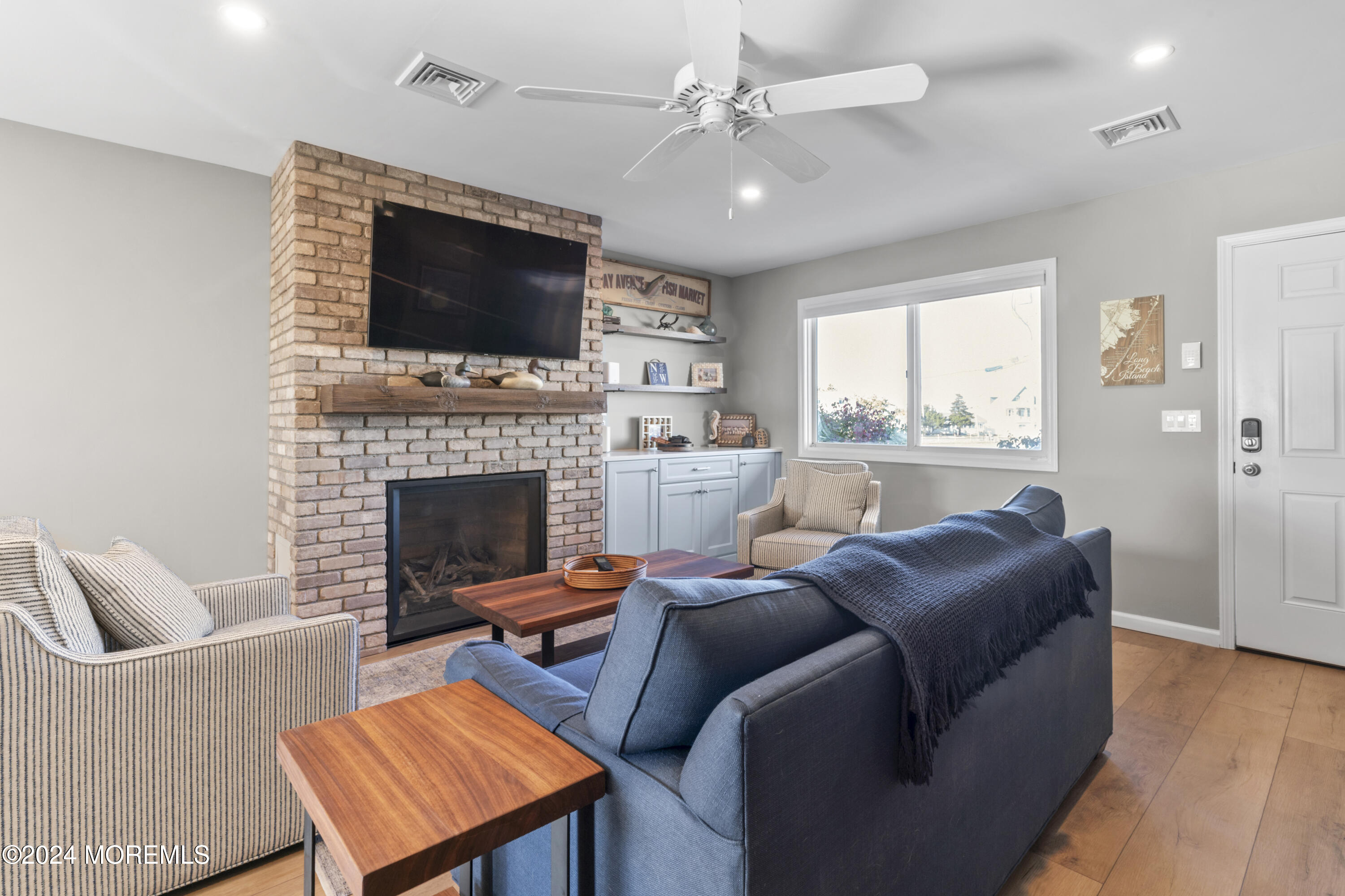 441 East Bay Avenue, Unit 10 Barnegat, NJ 08005 - Photo 13 of 53 a living room with furniture a flat screen tv and a fireplace