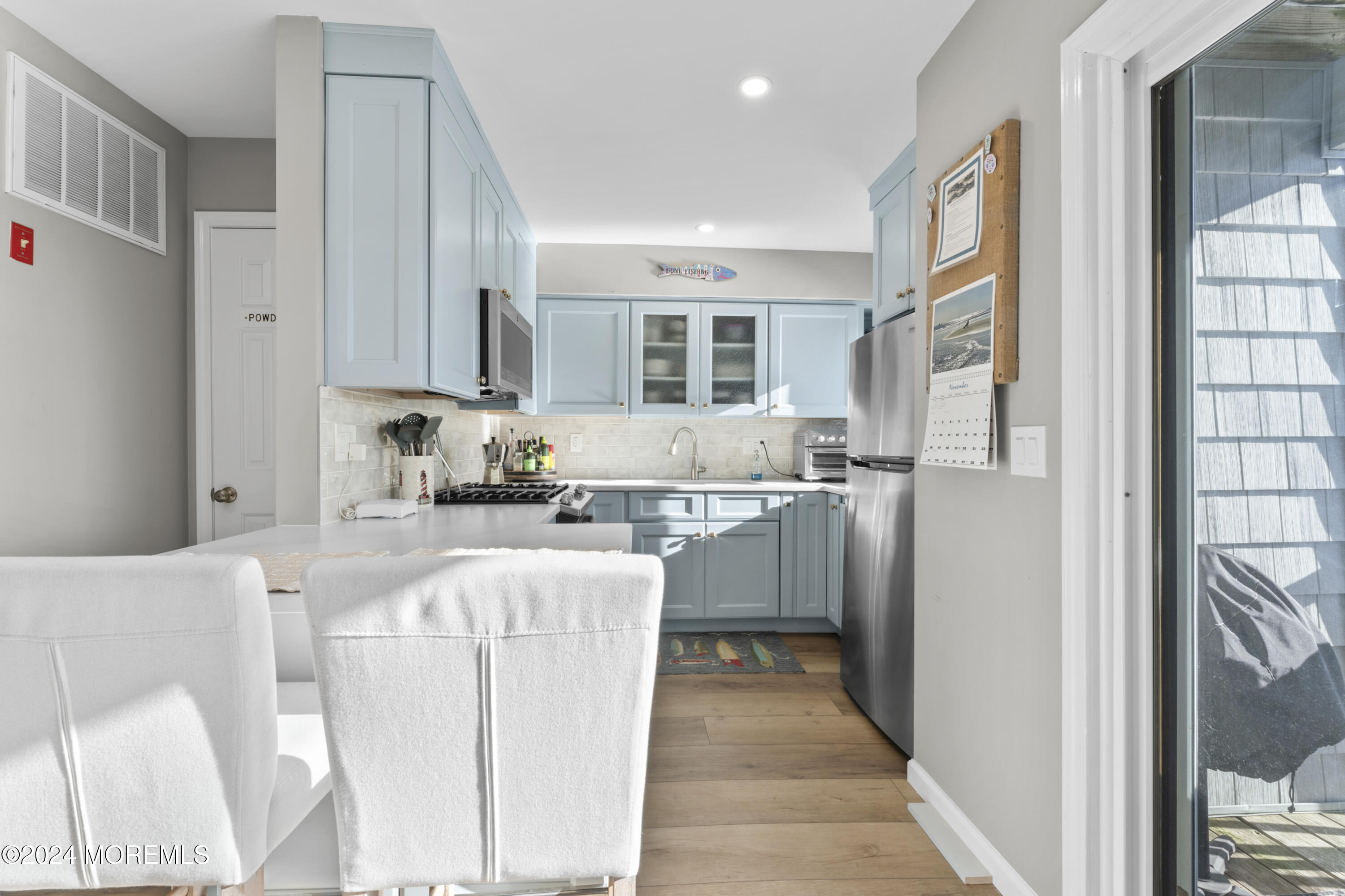 441 East Bay Avenue, Unit 10 Barnegat, NJ 08005 - Photo 18 of 53 a kitchen with stainless steel appliances granite countertop a refrigerator a sink dishwasher and white cabinets with wooden floor