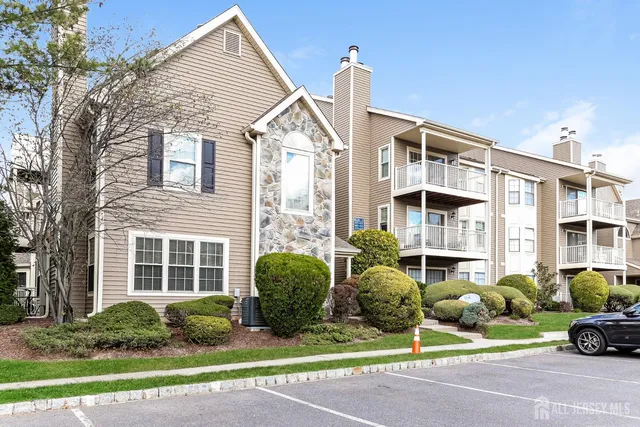 a front view of a house with a garden and plants