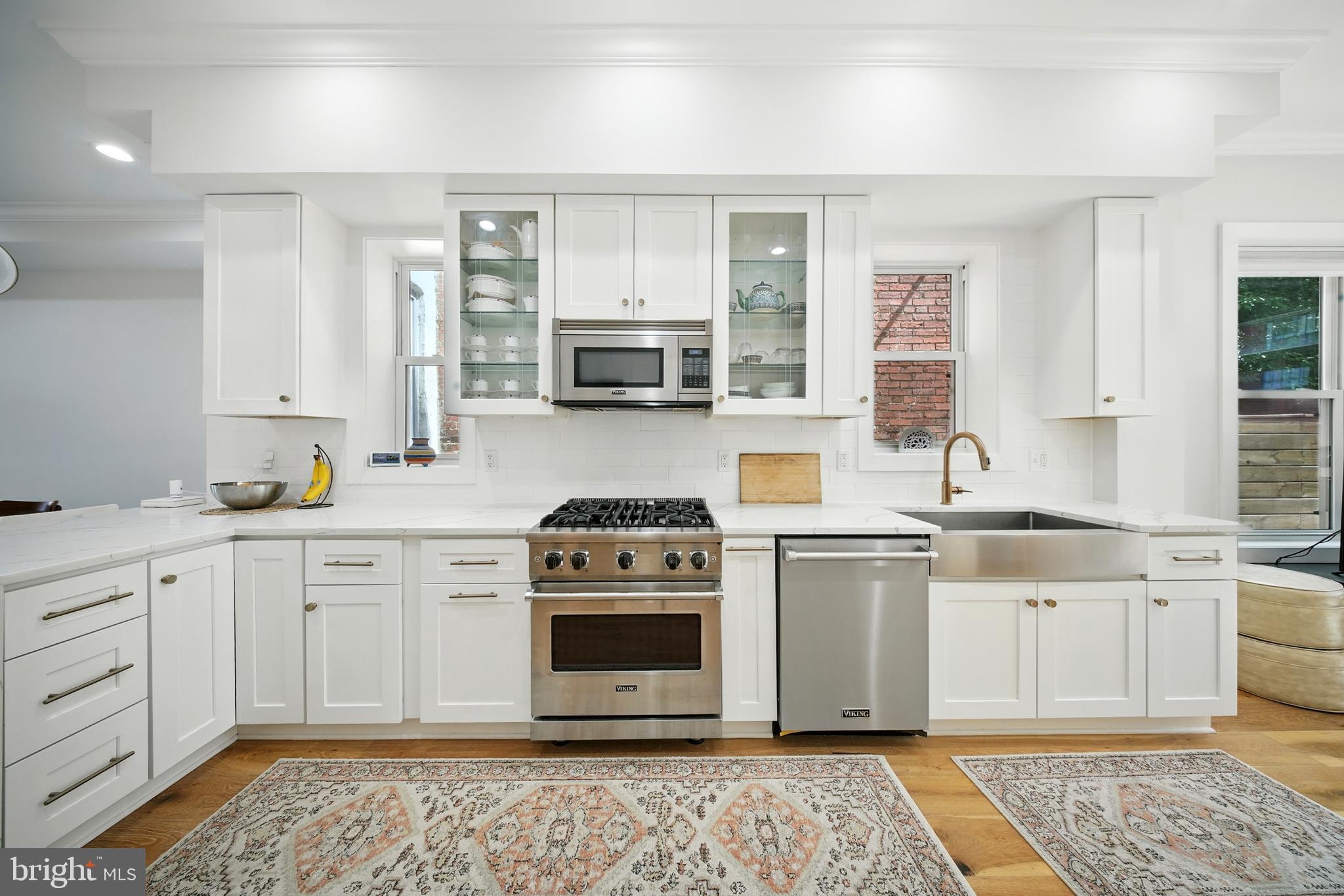 1831 North Capitol Street Northeast Washington, DC 20002 - Photo 1 of 39 a kitchen with stainless steel appliances granite countertop a stove a sink and a microwave