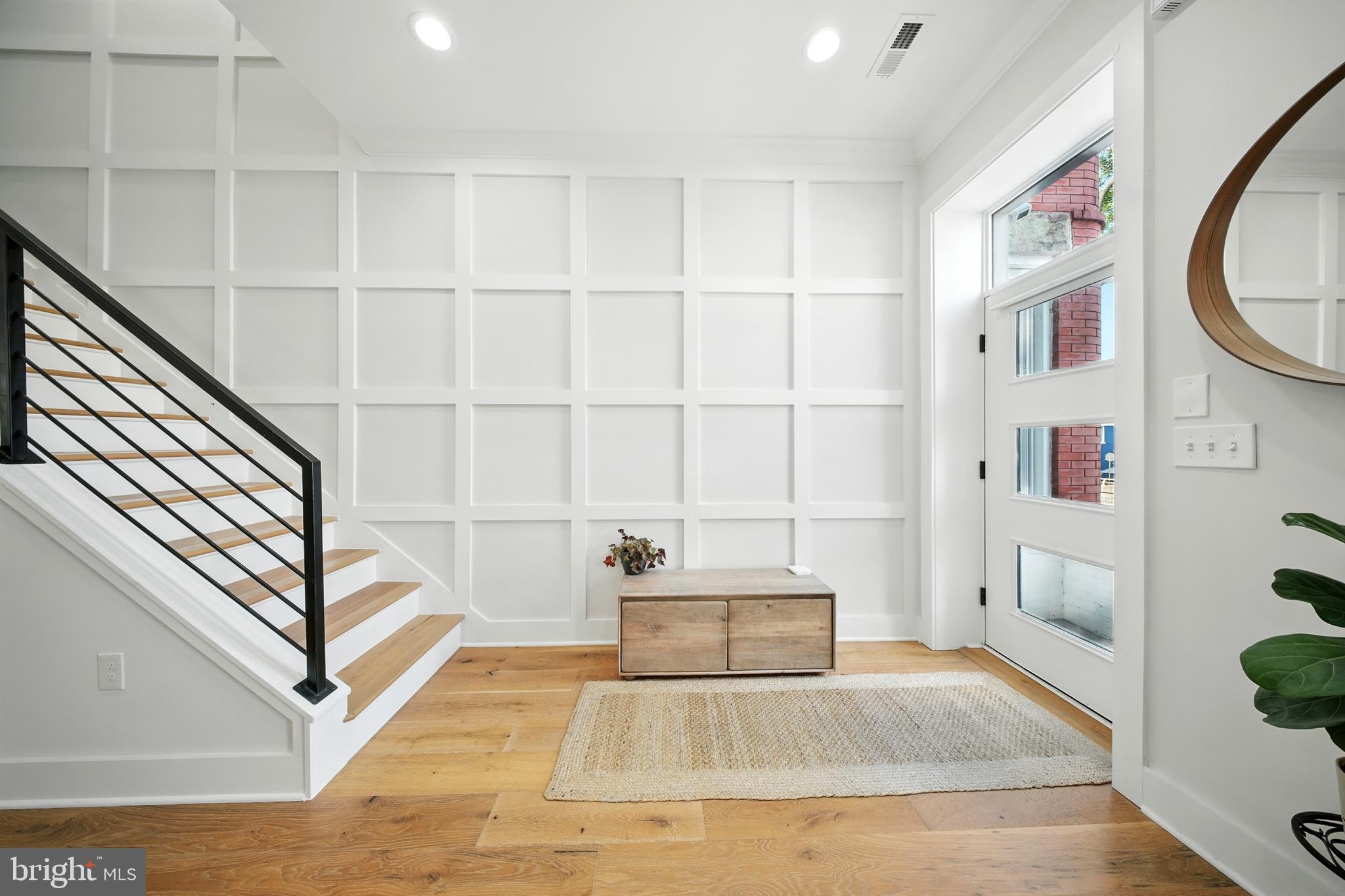 1831 North Capitol Street Northeast Washington, DC 20002 - Photo 3 of 39 a view of staircase with white walls and a window