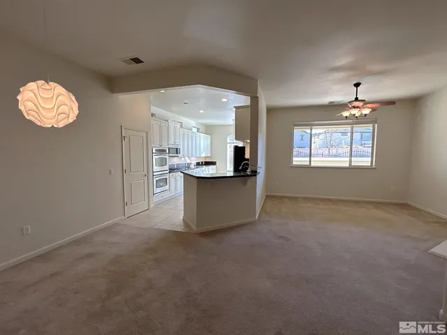 a view of a kitchen with windows and chandelier