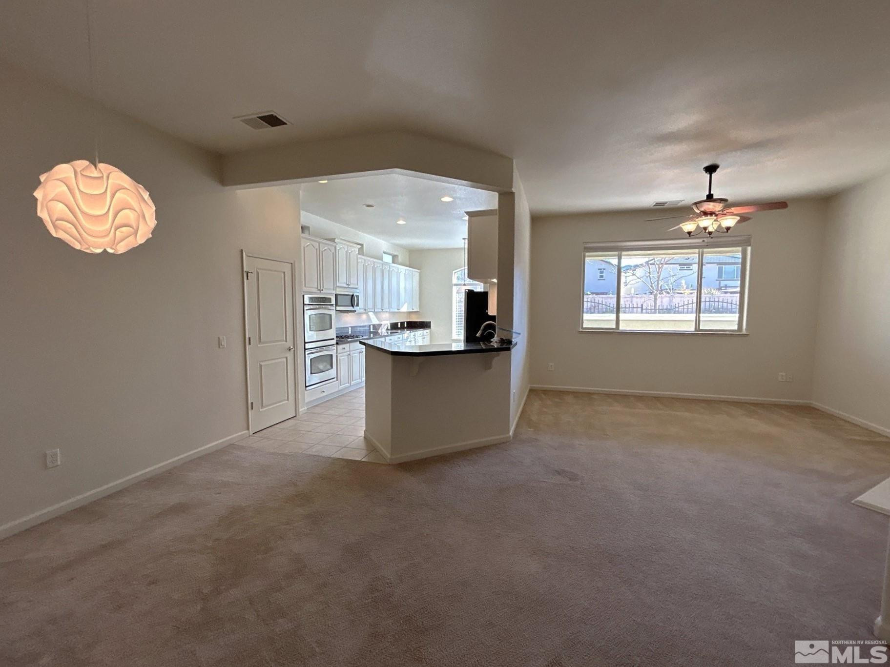 a view of a kitchen with windows and chandelier