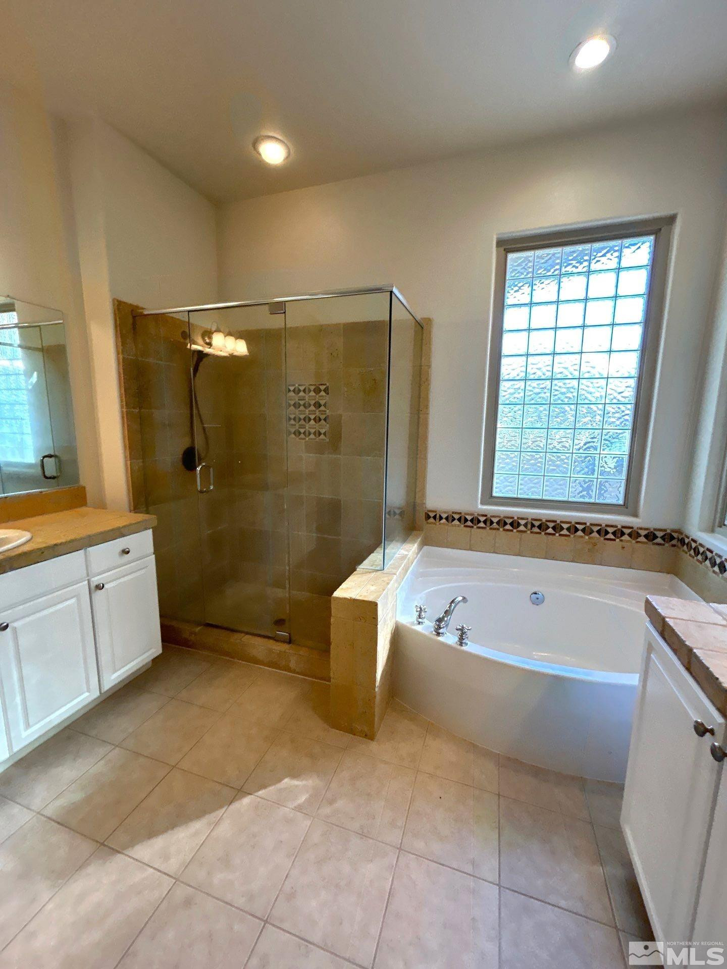 9900 Wilbur May Parkway, Unit 3402 Reno, NV 89521 - Photo 13 of 26 a bathroom with a tub a toilet a sink and shower