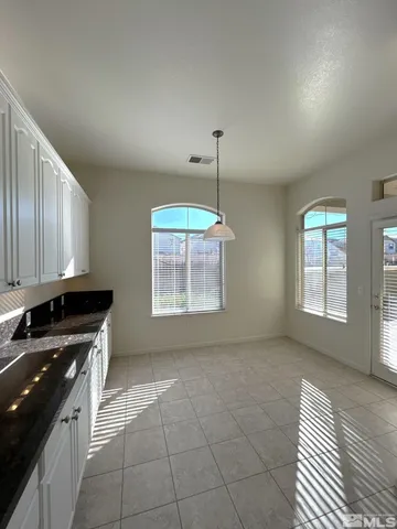a kitchen with a sink a stove cabinets and a wooden floor