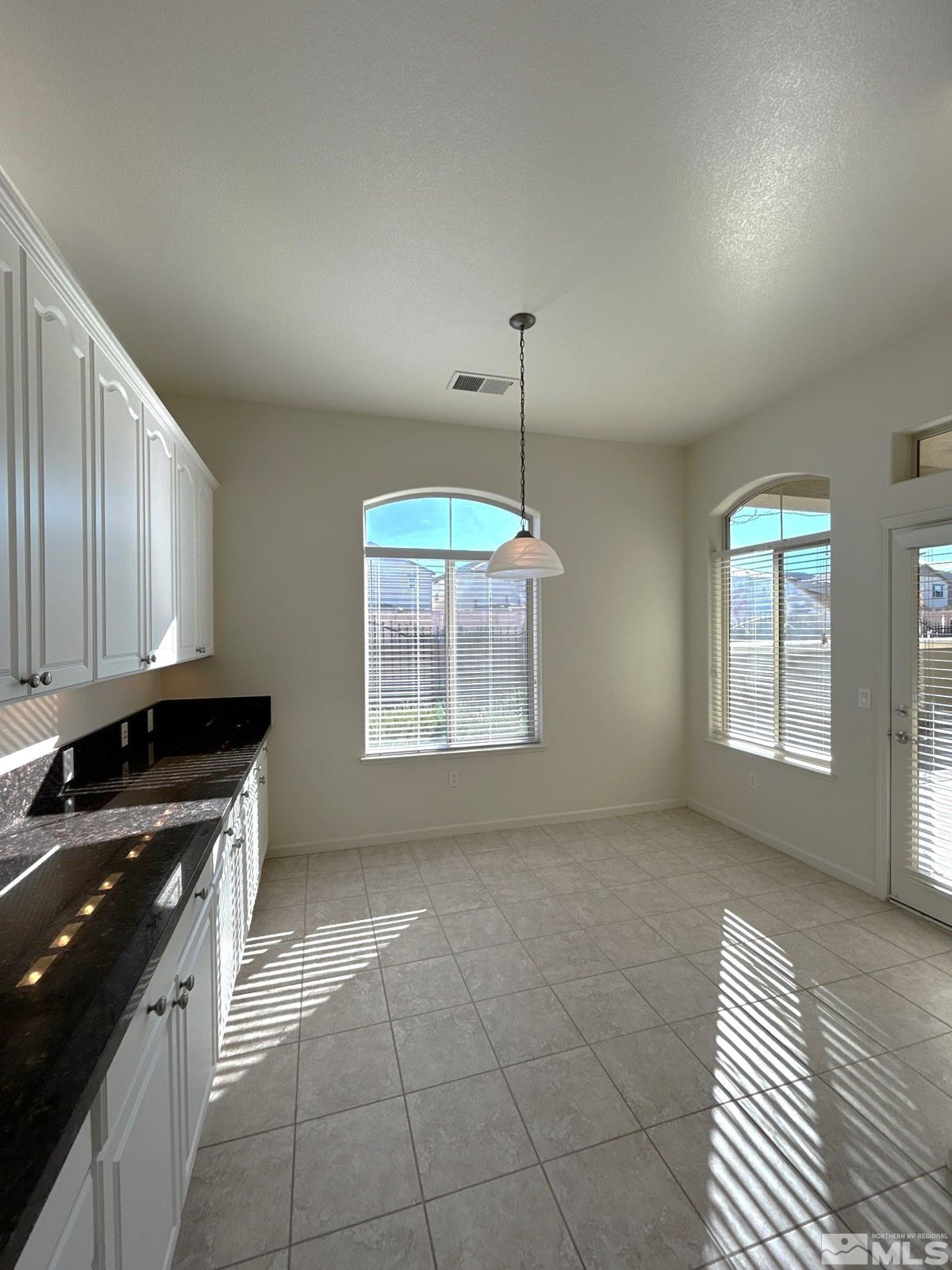 9900 Wilbur May Parkway, Unit 3402 Reno, NV 89521 - Photo 5 of 26 a kitchen with a sink a stove cabinets and a wooden floor