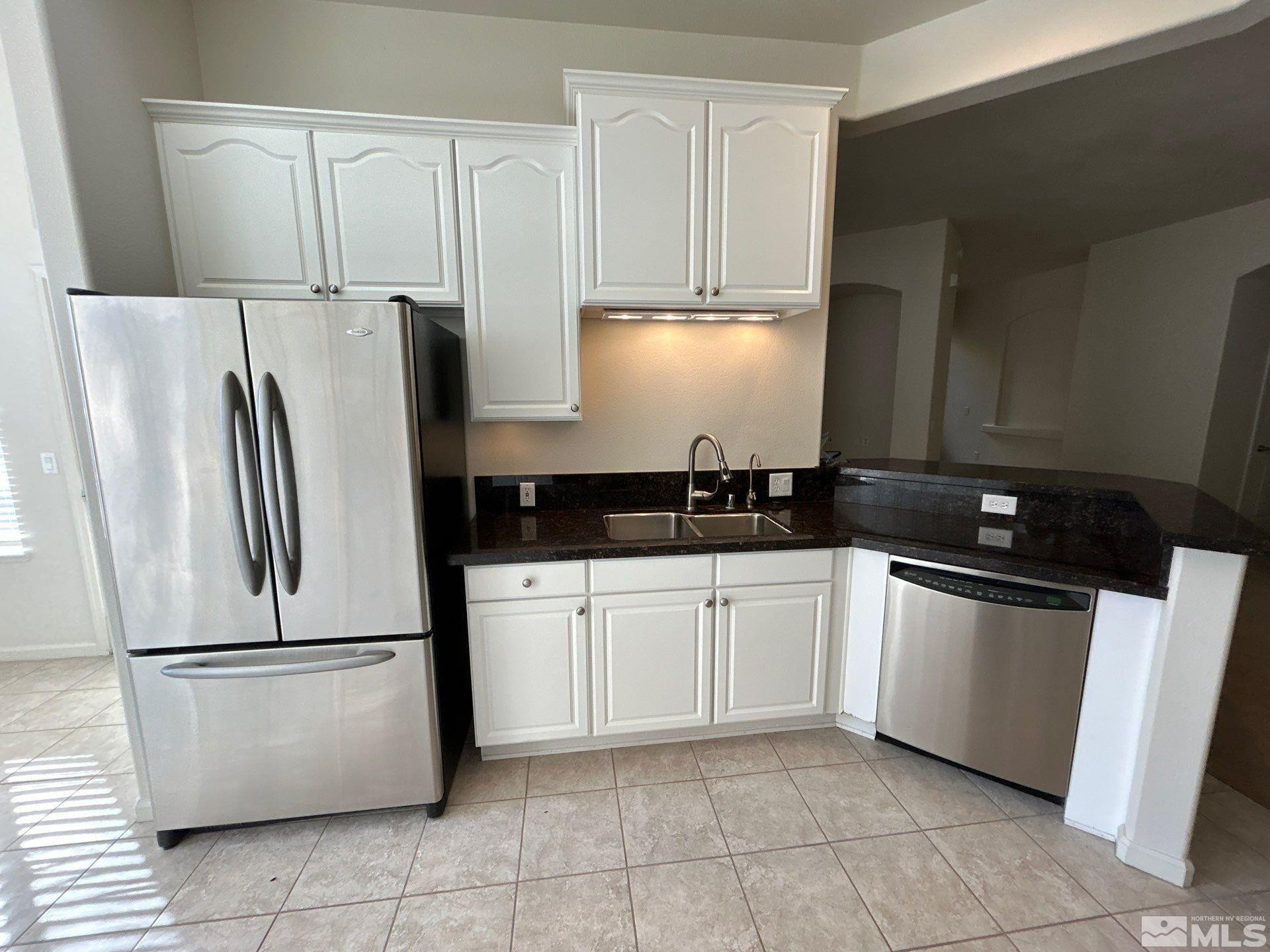 9900 Wilbur May Parkway, Unit 3402 Reno, NV 89521 - Photo 6 of 26 a kitchen with a refrigerator sink and cabinets