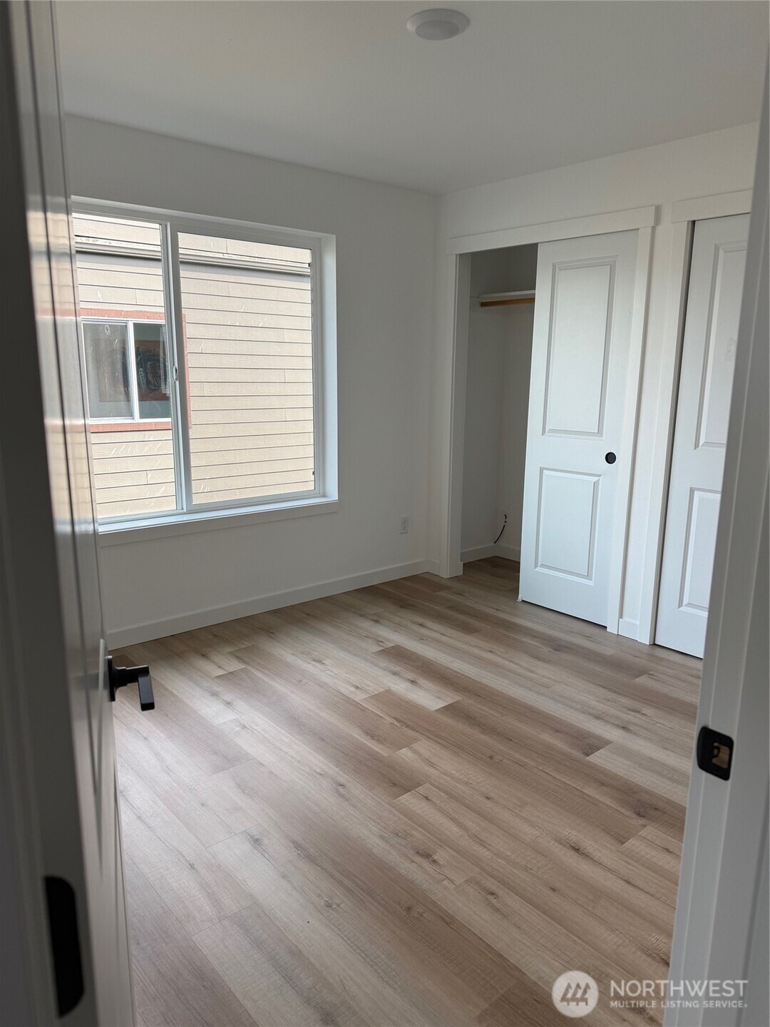 357 Martin Street Blaine, WA 98230 - Photo 11 of 18 a view of an empty room with a window and wooden floor