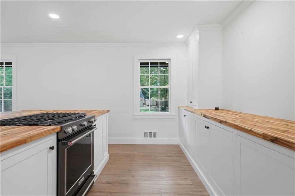125 Childers Road Canton, GA 30115 - Photo 15 of 48 a view of a kitchen with a sink dishwasher and wooden floor