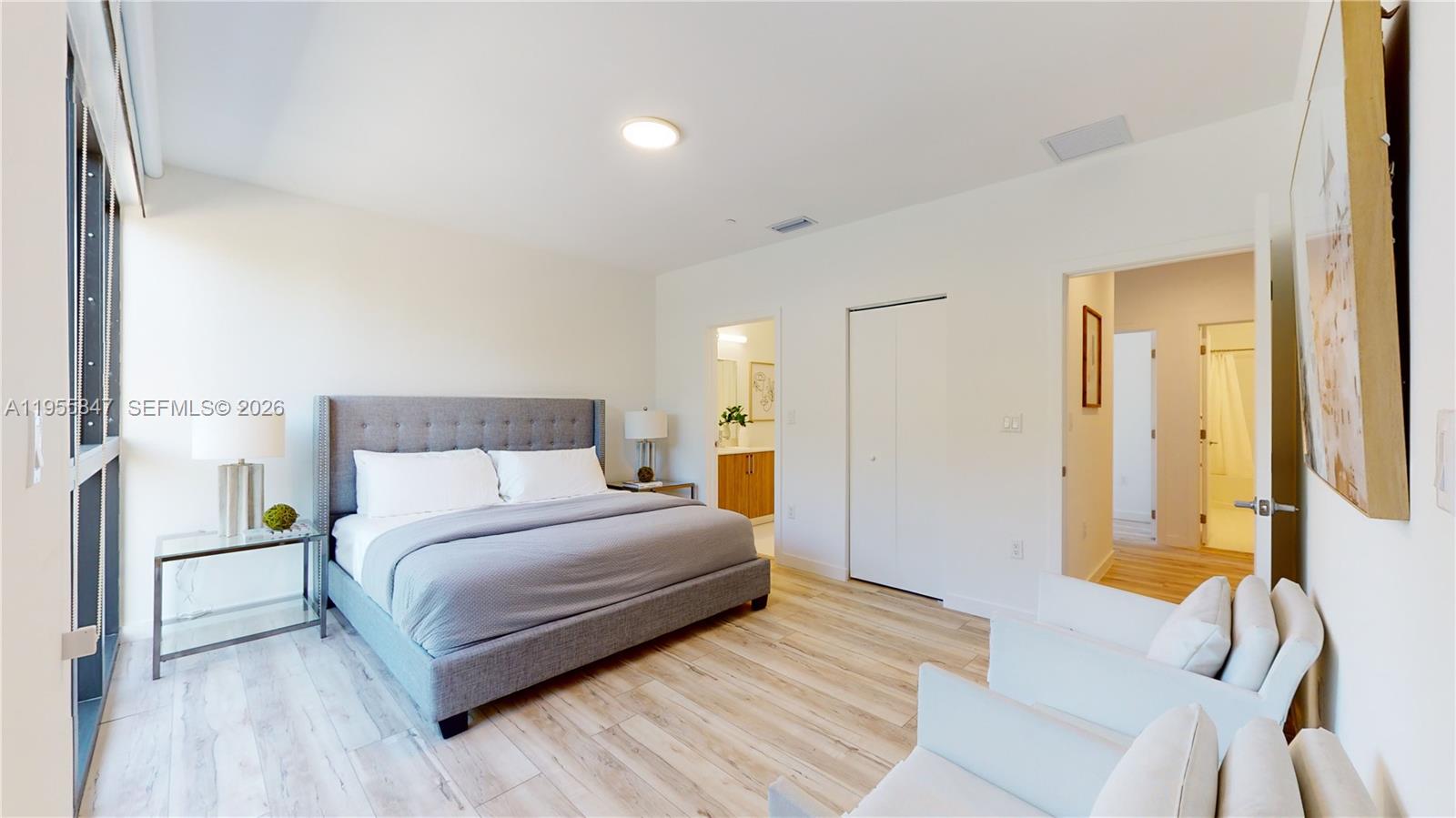 24705 Southwest 129th Avenue, Unit 107 Homestead, FL 33032 - Photo 13 of 33 a bedroom with a bed and a lamp