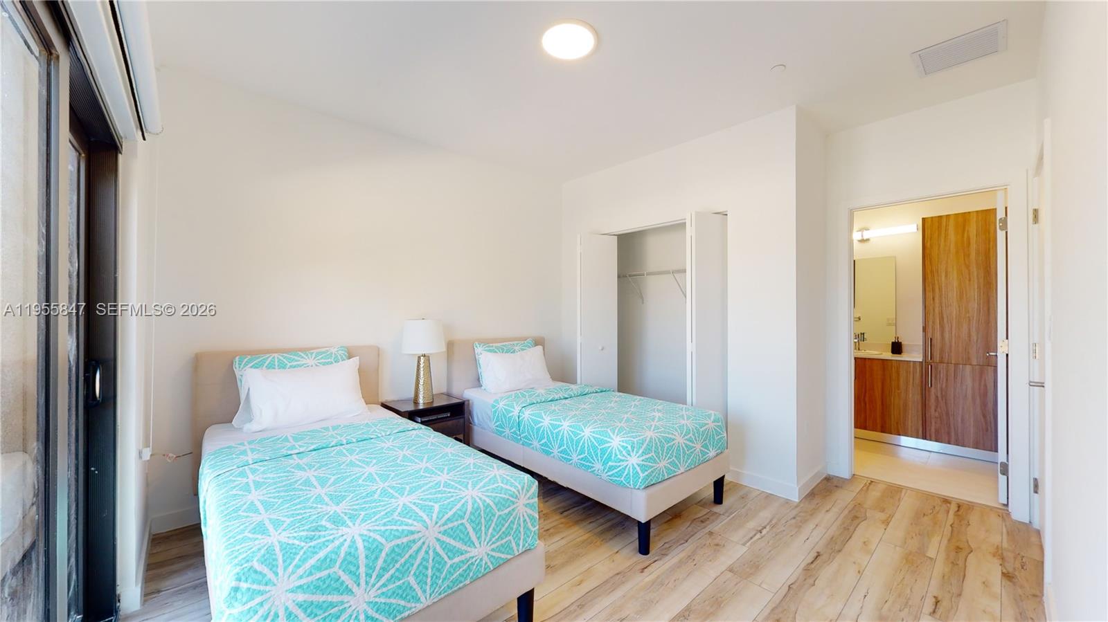 24705 Southwest 129th Avenue, Unit 107 Homestead, FL 33032 - Photo 28 of 33 a bedroom with two beds and painted walls