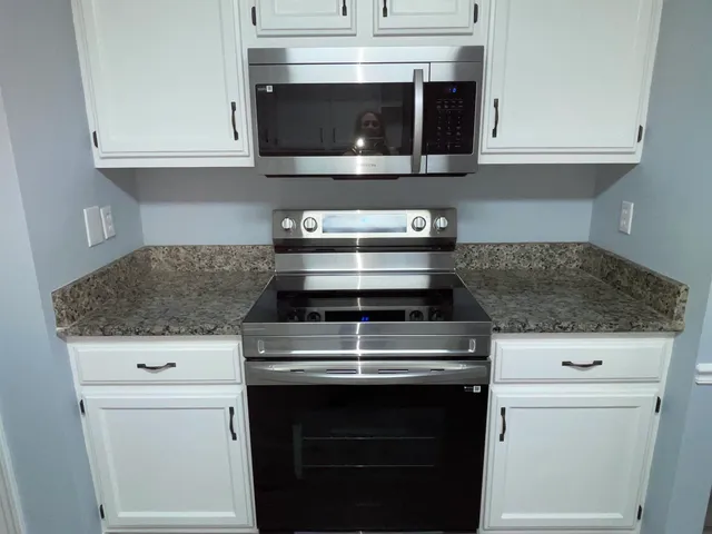 a stove top oven sitting inside of a kitchen
