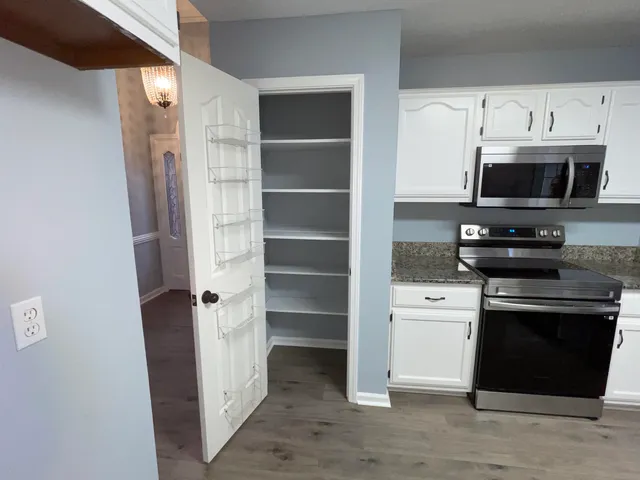 a kitchen with a stove and a microwave