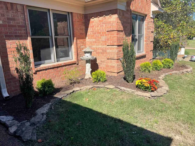 a front view of a house with garden