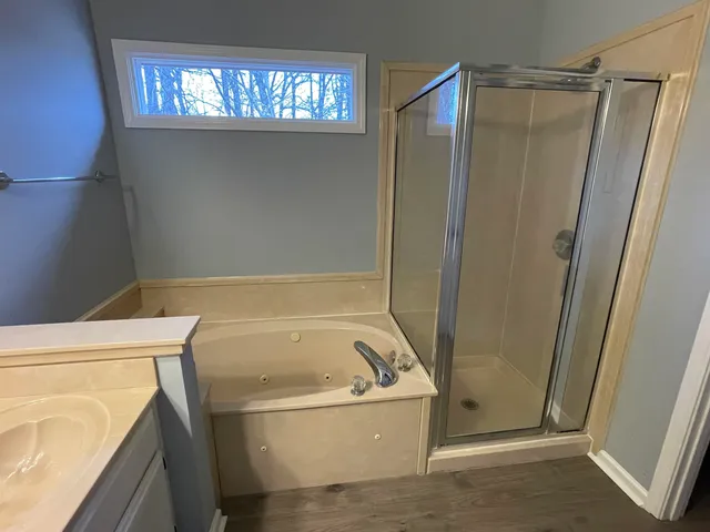a spacious bathroom with a granite countertop sink a toilet and a mirror