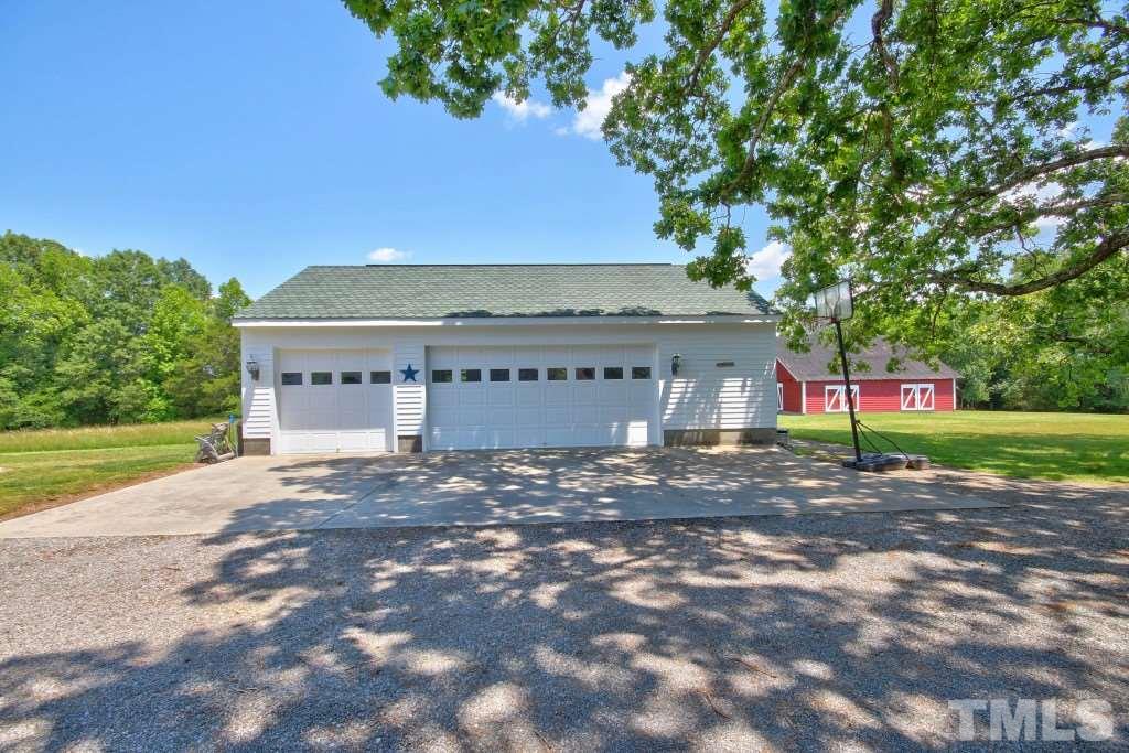 5504 Graham Daniel Road Rougemont, NC 27572 - Photo 22 of 25 a view of a house with a yard and garage