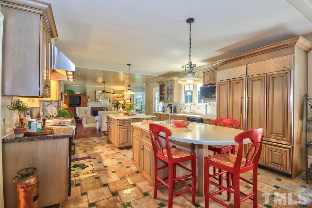 5504 Graham Daniel Road Rougemont, NC 27572 - Photo 6 of 25 a dining hall with stainless steel appliances kitchen island granite countertop a table and chairs