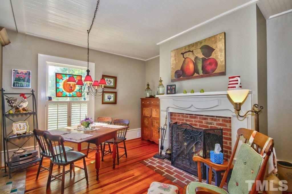5504 Graham Daniel Road Rougemont, NC 27572 - Photo 8 of 25 a living room with furniture a dining table and a fireplace