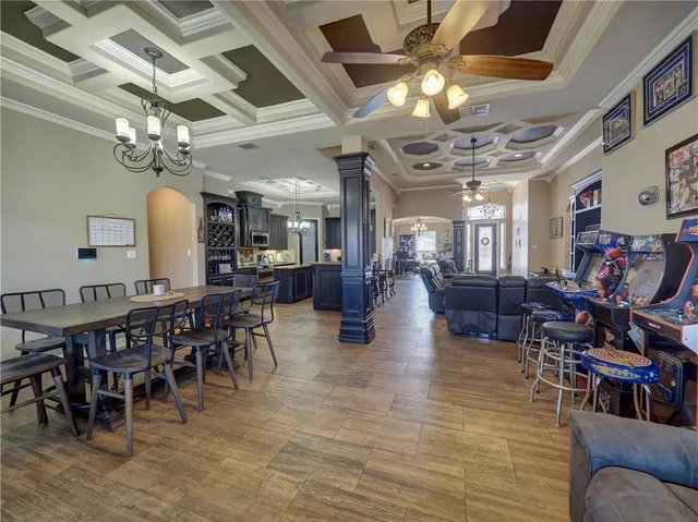 a living room with lots of furniture and a chandelier