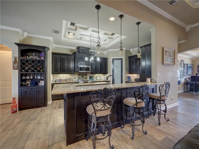 a large kitchen with a table and chairs