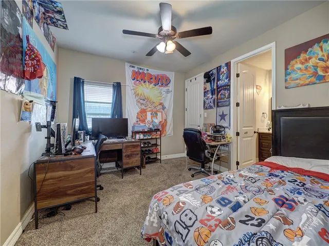 a spacious bathroom with a granite countertop sink and a toilet