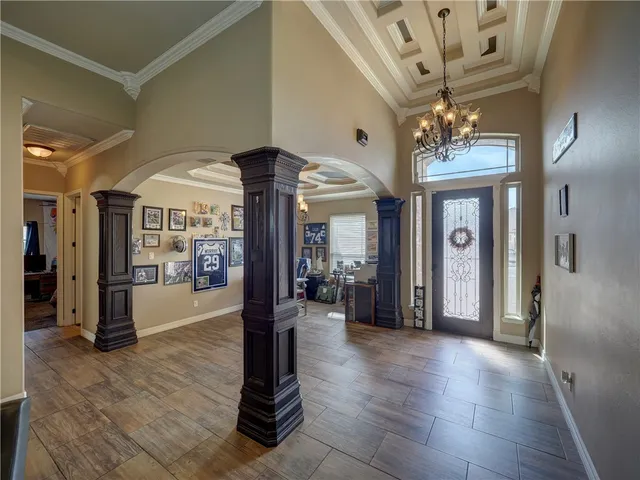 a view of a livingroom with a furniture chandelier and windows