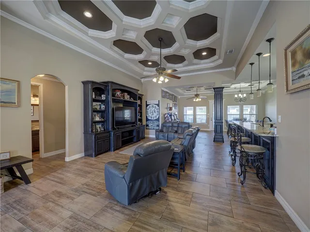 a living room with lots of furniture and wooden floors